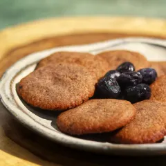 This is our Brown Butter Blueberry Cookie, a sugar-free, vegan, and high-protein delight. We use brown butter for its rich, toasty flavor and antioxidant properties, while blueberries add a burst of vitamins. Each cookie contains 31 grams of protein.