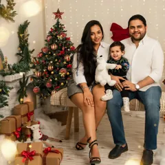 A beautiful family portrait from our Christmas mini sessions. The warm lights and festive decor create a cozy and joyful atmosphere perfect for capturing holiday memories.