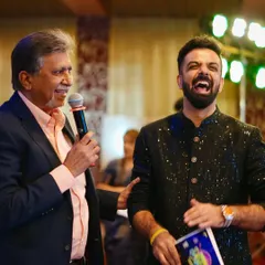 Sharing a moment of genuine laughter with a senior member of the Quess Corp team. Building rapport is key to a successful event.