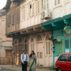Strolling hand-in-hand through the historic streets. This shot captures the feeling of exploring a city together, creating new memories.