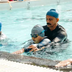 For me, coaching is personal. I take the time to provide one-on-one adjustments, ensuring every swimmer, like this young student, understands the feel of a correct stroke. This attention to detail is key to building a strong foundation.