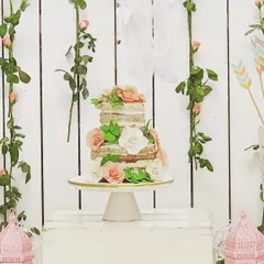 A beautiful naked cake for a boho-chic baby shower. The simple, rustic style of the cake, adorned with fresh roses, perfectly matched the bohemian theme.