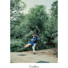 A fun, spontaneous lift captured in a park setting. These joyful, unscripted moments often become the couple's favorite photos.