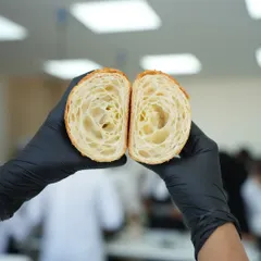 This perfect honeycomb structure is what every baker strives for in a croissant. It's a testament to mastering the lamination technique, which we teach in-depth to ensure you can create these buttery, airy pastries.