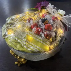 Another look at one of my signature illuminated gift hampers. This one is filled with assorted premium chocolates and other gourmet treats, all wrapped beautifully with a bow. It’s a gift designed to delight and impress.