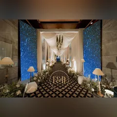This is how we make an entrance. A magical walkway designed for a winter-themed sangeet, using draped fabrics, custom geometric print flooring, and flanking LED screens that displayed a starry night sky, creating a truly immersive experience for the guests.