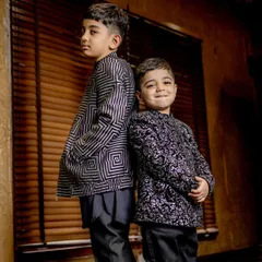 Back to back in style. This shot highlights the unique patterns of our custom bomber jackets, a perfect fusion of traditional motifs and modern silhouettes.