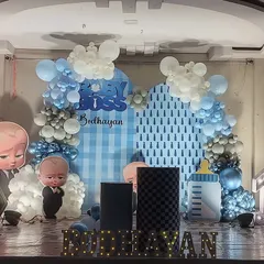 Another Boss Baby theme, this one showing a different style with a patterned backdrop and props like a giant baby bottle. I also included marquee letters with the child's name on the stage floor.