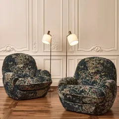 Two "Cluny" armchairs by Nobilis, upholstered in a rich tapestry velvet that evokes 17th-century Flanders. The deep, muted colorway and historic Verdure motif showcase our access to unique, heritage-inspired fabrics for creating truly statement-making upholstered pieces.