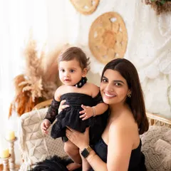 A classic mother-daughter portrait. The coordinating outfits and genuine smiles make this a photo to cherish.