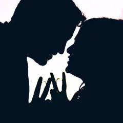 A simple yet powerful silhouette of a couple, their faces close, with their hands forming a heart shape.