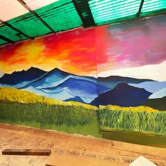 This angle shows how the sunset mural wraps around the space. The continuous landscape makes the room feel larger and more open.