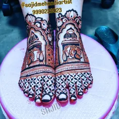 This bold feet design features architectural domes and peacock motifs. The toes are covered with a dense, dark geometric pattern, creating a striking contrast that is popular in bridal mehandi.