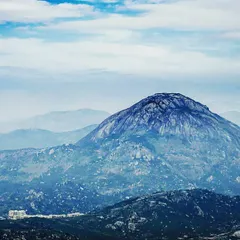 Another perspective of Nandi Hills, with a slightly different color treatment to create a cooler, more atmospheric feel. The building at the base gives a sense of scale to the massive rock formation.