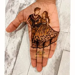 A minimalist yet elegant engagement design. This artwork focuses on the palm, featuring a beautifully detailed portrait of the couple in western attire, with the bride's flowing gown created from delicate henna patterns.