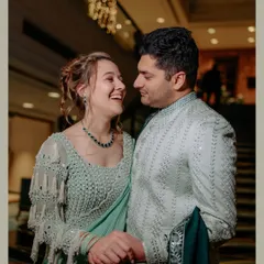 A beautiful moment from a fusion cocktail evening. The couple shares a laugh, showcasing a seamless blend of cultures and a chemistry that lights up the room.