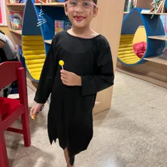 A spooky girl in her Halloween costume, ready to enjoy her lollipop treat. We encourage all the kids to come dressed up for our party.