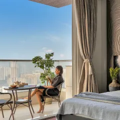 I believe a home should feel like a getaway. This bedroom, opening onto a balcony with a sweeping city view, is styled to create a staycation state of mind. It’s a peaceful escape where you can pause and enjoy the moment.
