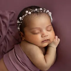 A beautiful close-up of this sleeping angel. The delicate pearl headband adds just a touch of elegance without distracting from her perfect little face.