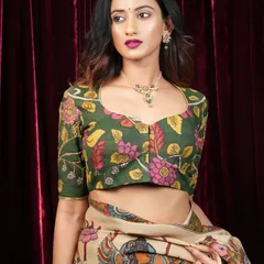 This green Kalamkari blouse features a classic sweetheart neckline and elbow-length sleeves. The floral pattern is hand-drawn, making it a unique piece of wearable art.