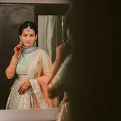 The final moments of getting ready are so special. Here, the bride is having a final look in the mirror. I always ensure every detail is perfect so my clients feel completely confident and beautiful.