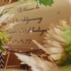 A close-up of the welcome mirror being prepped for a tropical-themed party.
