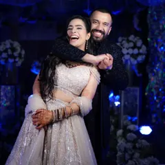 Pure, uninhibited joy. This candid shot of the couple laughing together shows the fun and relaxed atmosphere we strive to capture during your celebrations.