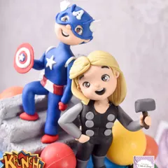A close-up of the Captain America and Thor chibi-style figurines from the Avengers cake. Creating these cute, stylized versions of popular characters is one of my favorite things to do.