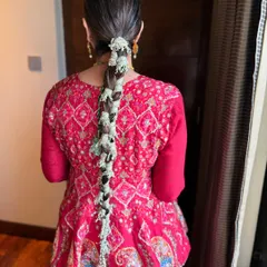 Gota in her braid and joy in her soul. This Mehendi look features a unique gota braid and clean, minimal makeup for a fresh and modern take on festive style.