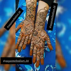 Another view of this intricate floral mehendi design. The solid-filled fingertips are a classic touch that provides a beautiful contrast to the detailed work on the hands and arms.
