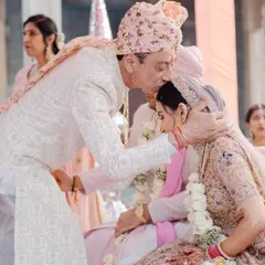 A father's emotional kiss for his daughter on her wedding day. A powerful, candid moment that speaks volumes about family bonds and the significance of the day.