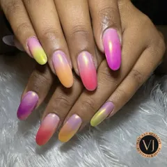 A different angle of our popular sunset ombré nails, showing the seamless blend of vibrant colors on long, oval-shaped extensions. The glossy finish enhances the beautiful color transition from every viewpoint.