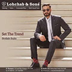 Set your own trend with a stylishly fitted pinstripe suit. The modern cut and sharp tailoring make this a standout piece, showing how classic patterns can be adapted for a contemporary look.