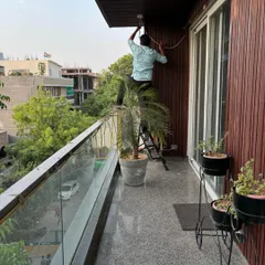 My team is equipped to handle installations in any environment, including modern residential buildings. Here, we are carefully mounting a camera on a balcony in GK-1, ensuring neat wiring and optimal placement for street-level monitoring.