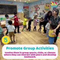 Promoting group activities like this "train" game is key to social development. Children learn to work together and coordinate their movements, all while having fun.