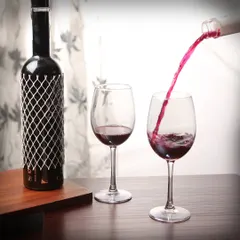 We excel at capturing dynamic action shots that bring beverages to life. This photograph freezes the moment of red wine being poured, highlighting the liquid's color and motion, a technique that adds energy and appeal to product listings and promotional materials.