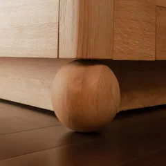 Even the feet of a piece of furniture deserve careful consideration. This solid wood spherical foot provides a strong yet gentle foundation for a cabinet, a small detail that adds immense character and a sense of grounding to the design.