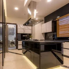 This is where culinary magic happens. I design modular kitchens that are not just beautiful but also highly functional, like this stunning island kitchen with a high-gloss black finish, marble accents, and smart lighting for a truly premium cooking experience.