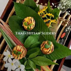Our Thai-Haitian sliders, beautifully presented on fresh leaves and flowers for a tropical feel.