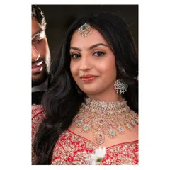 A beautiful close-up of Likitha's reception makeup. The soft glam look features a glossy nude lip and defined eyes, perfectly complementing her magnificent diamond jewelry set.