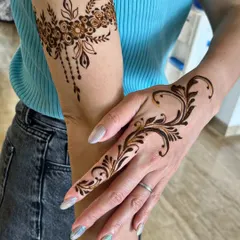 Life is too short for boring nails, so spice it up with some mehndi. This is a perfect example of a modern, stylish design with an arm band and a finger vine.