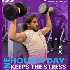 One hour a day is all it takes to build strength and keep stress away. Here, a member performs a seated dumbbell shoulder press, a fundamental exercise for developing powerful shoulders.