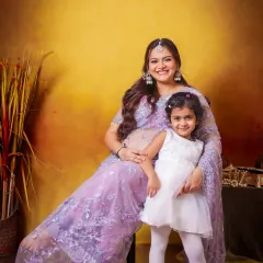 I believe in celebrating motherhood with grace and tradition. This portrait features a mother-to-be in a beautiful saree, capturing her elegance and the sweet bond with her older daughter during this special time.