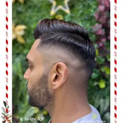 Precision is key in our men's grooming services. Here, we've crafted a sharp skin fade that blends seamlessly into a styled, voluminous top for a clean and modern look.