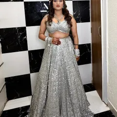 My modern bride shining in a glamorous silver sequin lehenga. I gave her a soft glam look with defined eyes and wavy hair to complete this stunning reception outfit.