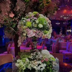 An unapologetic flush of sparkle and glitter. This close-up of a floral centerpiece on a mirrored table reflects the dazzling ballroom, filled with light and luxury to celebrate two special souls.