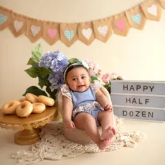 This little cutie is all smiles for her half-birthday celebration. My studio has all the props, like this lightbox and banner, to make any milestone shoot special.