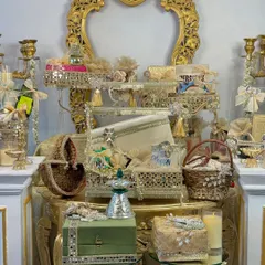 My 'Chandni Raatein' collection is an ode to the magic of festive nights. This display showcases a variety of my luxury Diwali hampers, featuring ornate mirrored baskets, velvet boxes, and antique-style stands, all filled with thoughtful treats.
