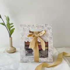 Our Mini Rakhi Hamper is perfect for a sweet and simple gesture. Packaged in a lovely window box, it contains a selection of our Regal Riches, choco almonds, and wheat cookies, complete with a Rakhi.