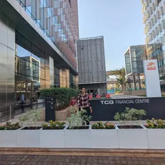 Here is the finished installation at the TCG Financial Centre in BKC, Mumbai. The clean lines of the light-colored, rectangular FRP planters create a modern and welcoming entrance, filled with a mix of Variegated Tagar and Ixora plants that add texture and color.